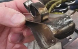 An example of a brush-holder spring that overheated due to brush failure of a copper compound. The intense heat on the phase has caused the brush top to melt and the spring to then temper.